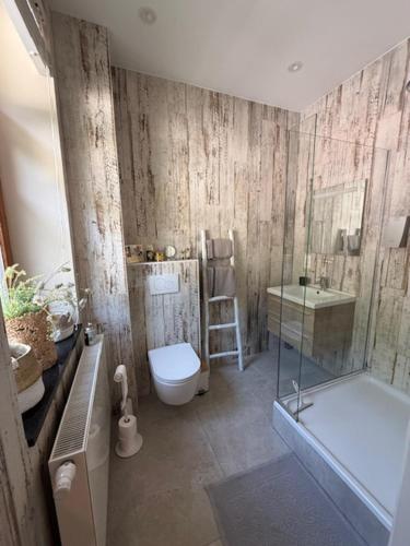 a bathroom with a tub and a toilet and a shower at Le Jardin Des Secrets "Gites et chambres à louer" in Namur
