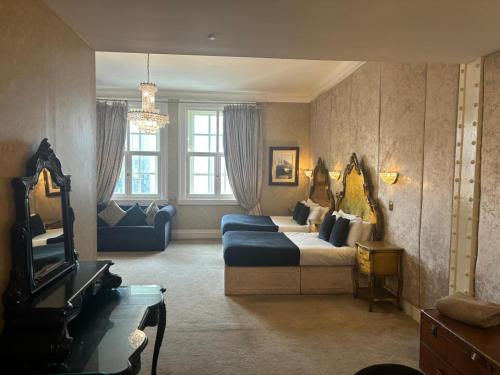 a large living room with a couch and a tv at White Star Line Hotel in Liverpool