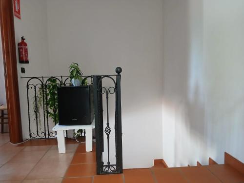 a tv sitting on a table next to a fence at La casa di ale in Latina