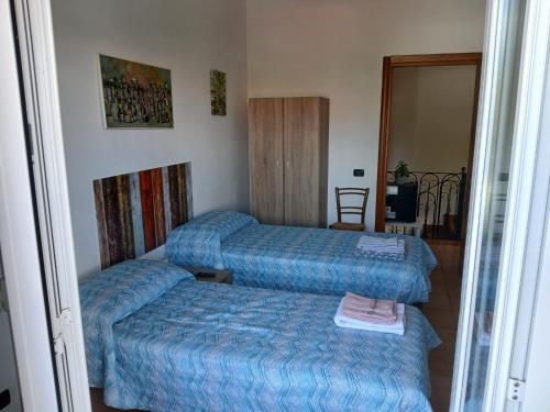 a hotel room with two beds and a television at La casa di ale in Latina