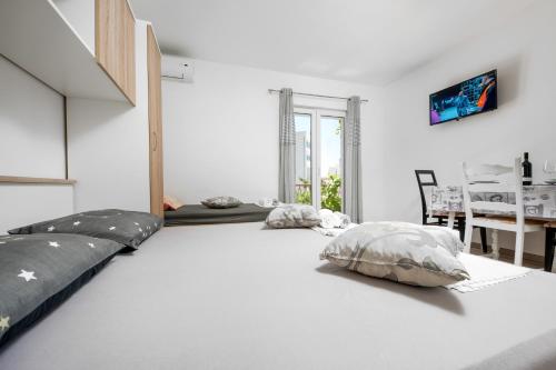 a white room with two pillows on the floor at Apartman Biljana in Makarska