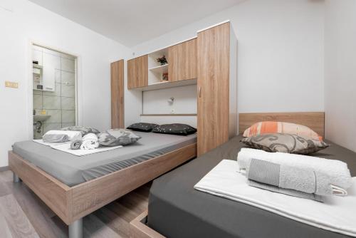 a bedroom with a large bed with two pillows at Apartman Biljana in Makarska