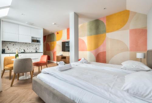 a bedroom with a large bed with a colorful wall at Retro Boutique by NorthSide Apartments in Gdańsk