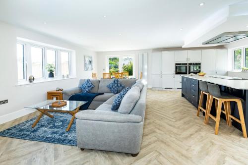 a living room with a couch and a table at NEW! Stunning & Huge 5BR with Parking & Garden - Perfect for Families & Groups! Excellent Location in Saint Leonards