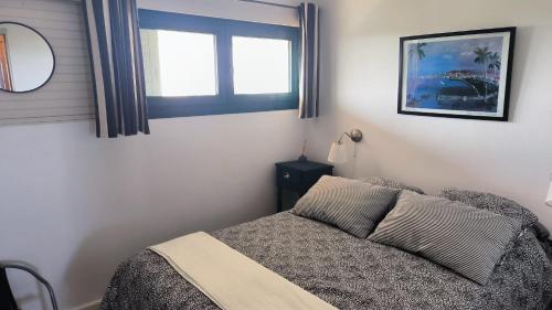 une chambre avec un lit et une fenêtre dans l'établissement Appart modernise vue mer ambiance Marine, à Saint Cyprien Plage