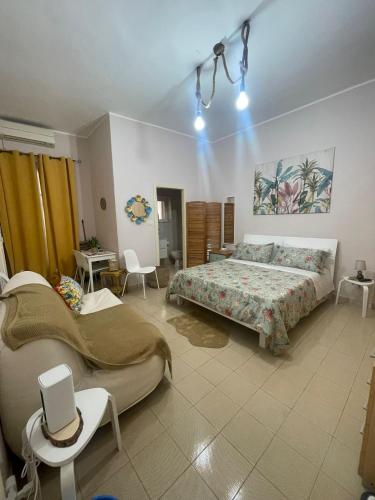 a bedroom with a bed and a table and chairs at residence Gaja in Gaeta