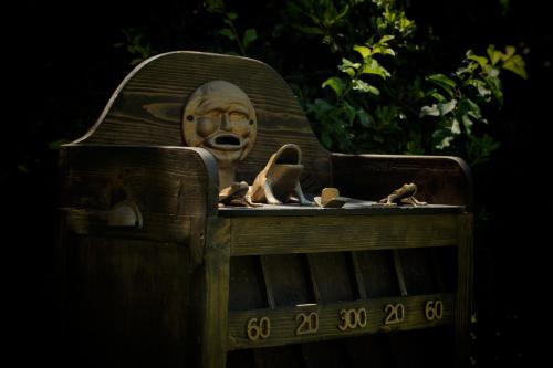 a wooden bench with a head on top of it at La Masia in Chacras de Coria