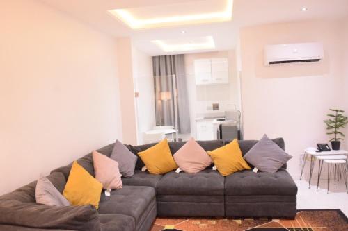 a living room with a couch with colorful pillows at Wallgate Apartments Limited in Jahi