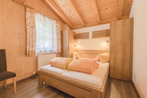 a bedroom with two beds in a room with a window at Steineggerhof in Valle Di Casies