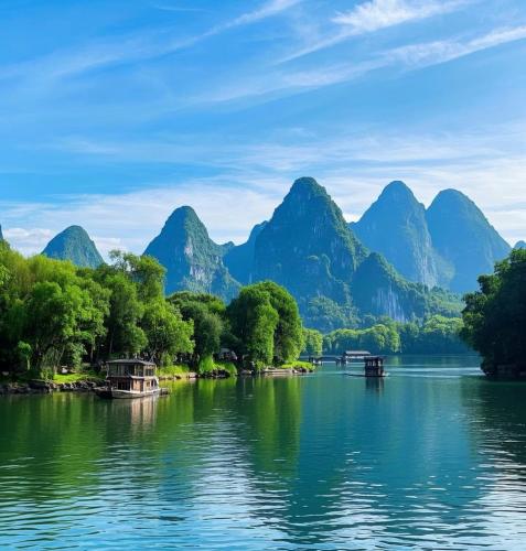 a view of a river with mountains in the background at Li-river Island Resort Xingping Yangshuo in Yangshuo