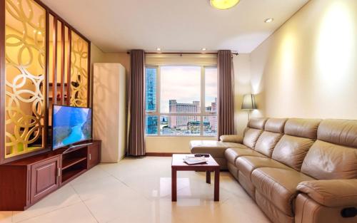 a living room with a couch and a flat screen tv at Premium Suites - Lancaster Building, Saigon-Japanese Town, SG's Heart in Ho Chi Minh City