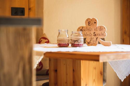 a table with two jars of jam on it at Steineggerhof in Valle Di Casies
