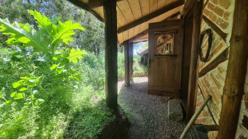 an outside view of a building with a wooden door at La Colibe, cătun arhaic ecologic in Constanţa