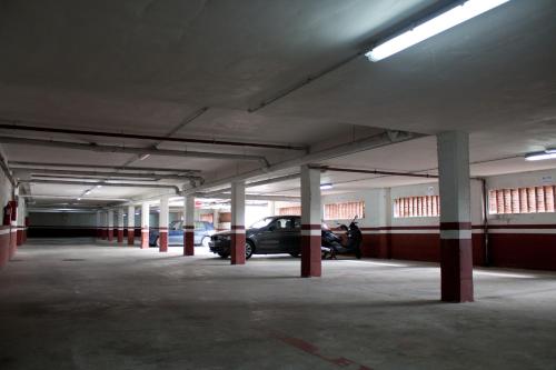 an empty parking garage with a car parked in it at Abba Comillas Apartments in Comillas