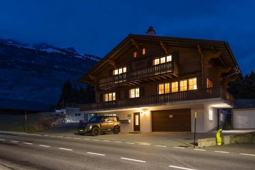 a car parked in front of a house at Chalet Gemsblick in Hospental