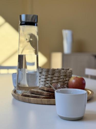 a table with a bottle of oil and a plate of food at Les Clavendiers - Le Refuge in Nuits-Saint-Georges