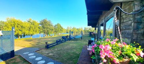 a building with benches and flowers in a park at Lakeview Petting Pod in Chelmsford