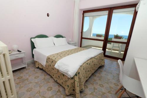 Postel nebo postele na pokoji v ubytování Hotel Il Vascello