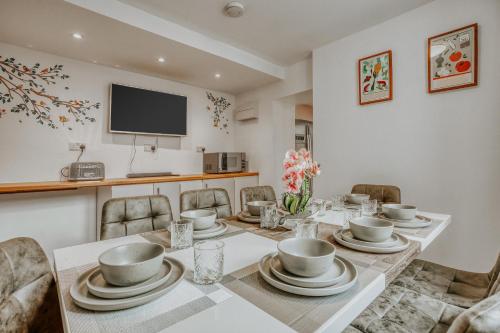 a dining room with a table and chairs at Open Mind Property - 4 Bedroom House with Hot Tub in Weston-super-Mare