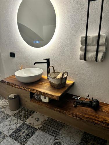 a bathroom with a sink and a mirror at la nicchia, relax room & salento stay in Manduria