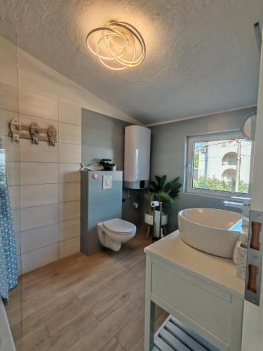 a bathroom with a sink and a toilet at Rosemary Resort in Cesarica