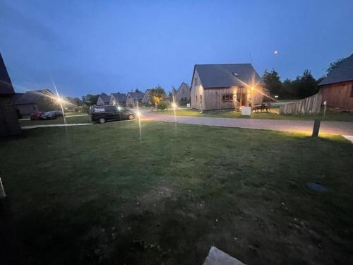 a yard with lights in the grass at night at James Ville Marina, Lodge 9 in Brigg