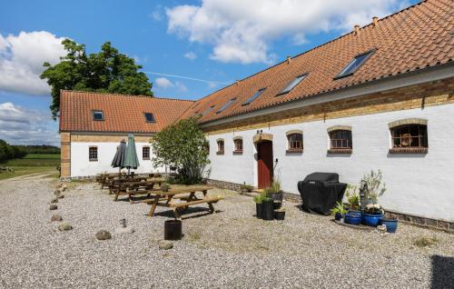 a group of benches in front of a building at 7 Bedroom Stunning Home In Grenaa - D70125 in Rimsø