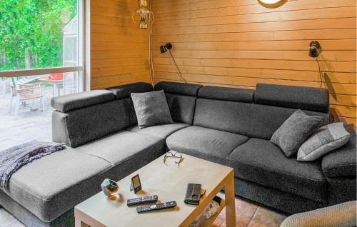 a living room with a couch and a table at Three Bedroom Cozy Home In Ebeltoft in Ebeltoft