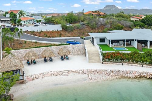 an aerial view of a villa with a resort at Dolce Vita Beach, Waterfront Bungalows with Private Beach in Willemstad