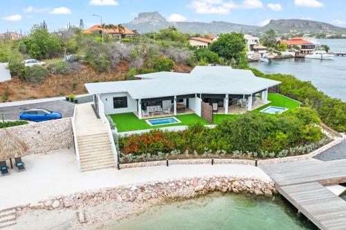 an aerial view of a house on the water at Dolce Vita Beach, Waterfront Bungalows with Private Beach in Willemstad