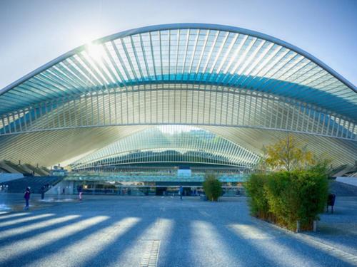 a large building with a curved roof in a city at La renaissance in Villers-lʼÉvêque