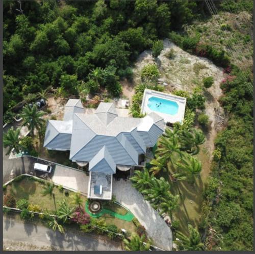 an aerial view of a house with a swimming pool at Emerald Sea View in Montego Bay