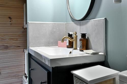 a bathroom with a sink and a mirror at Cabane Petit Bouddha in Arrien-en-Bethmale
