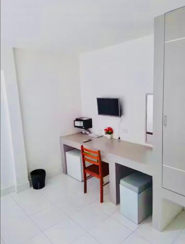 a room with a desk with a computer and a chair at SET INN restaurant & bar 1 & 2 in Kata Beach