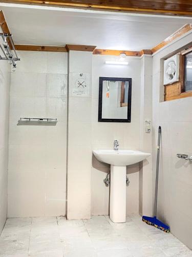 a bathroom with a sink and a shower at The Nest Farm Stay in Karsog in Karsog