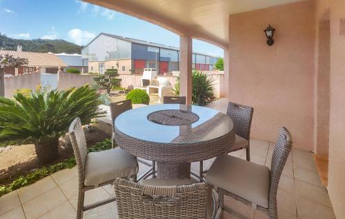 a patio with a table and chairs on a balcony at Nice Home In Cessenon Sur Orb - Flh677 in Cessenon