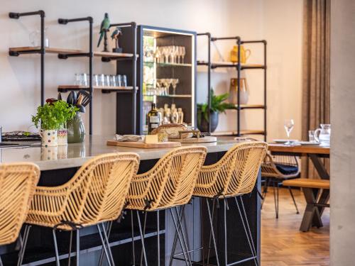 a bar with rattan chairs in a room at 5 Bed in Westward Ho 78690 in Bideford