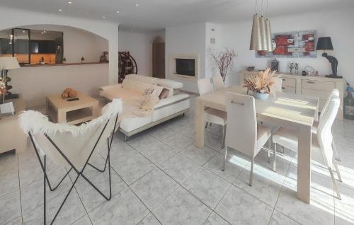 a living room with a couch and a table at Nice Home In Cessenon Sur Orb - Flh677 in Cessenon
