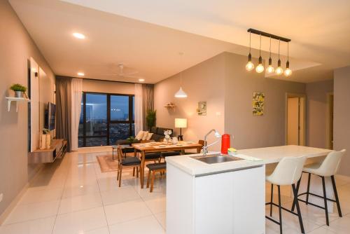 a kitchen and living room with a table and chairs at Midvalley Southkey Mosaic Suite by Nest Home in Johor Bahru