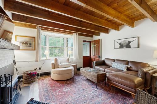 a living room with a couch and a chair at Quechee Hollow 2C in Quechee