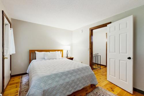 a bedroom with a bed and an open door at Quechee Hollow 2C in Quechee