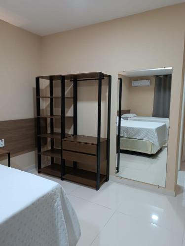 a bedroom with a bed and a large mirror at Hotel do Grande Rio in Petrolina