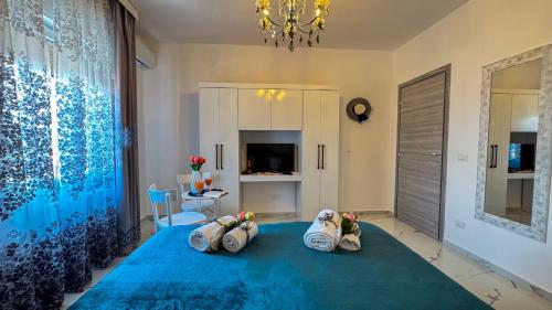a bedroom with a blue bed with three pillows at B&B Antenna 2 by Ca-Sa Check in Chioggia
