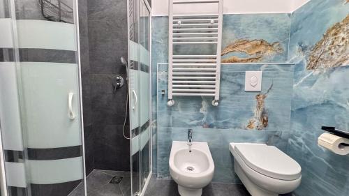 a bathroom with a toilet and a glass shower at B&B Antenna 2 by Ca-Sa Check in Chioggia