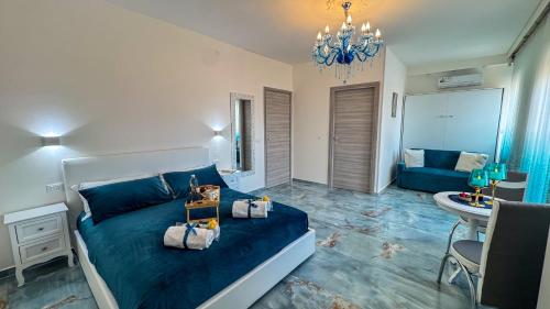 a bedroom with a blue bed and a living room at B&B Antenna 2 by Ca-Sa Check in Chioggia