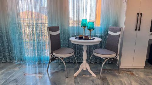 a table with two chairs and a table with two wine glasses at B&B Antenna 2 by Ca-Sa Check in Chioggia