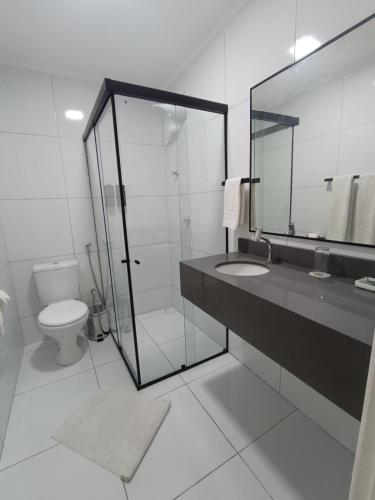 a bathroom with a shower and a sink and a toilet at Hotel do Grande Rio in Petrolina