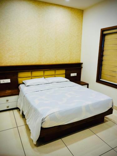 a bedroom with a large bed in a room at Executive Room in Kelakam