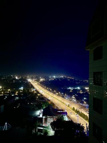 a night view of a bridge over a city at WOOD apartments in Osh