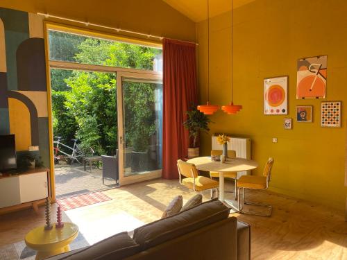 a living room with a couch and a table at Assen-Groningen-Saunacabine in Vries